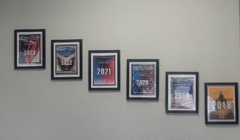 A group of framed pictures hanging on a wall.